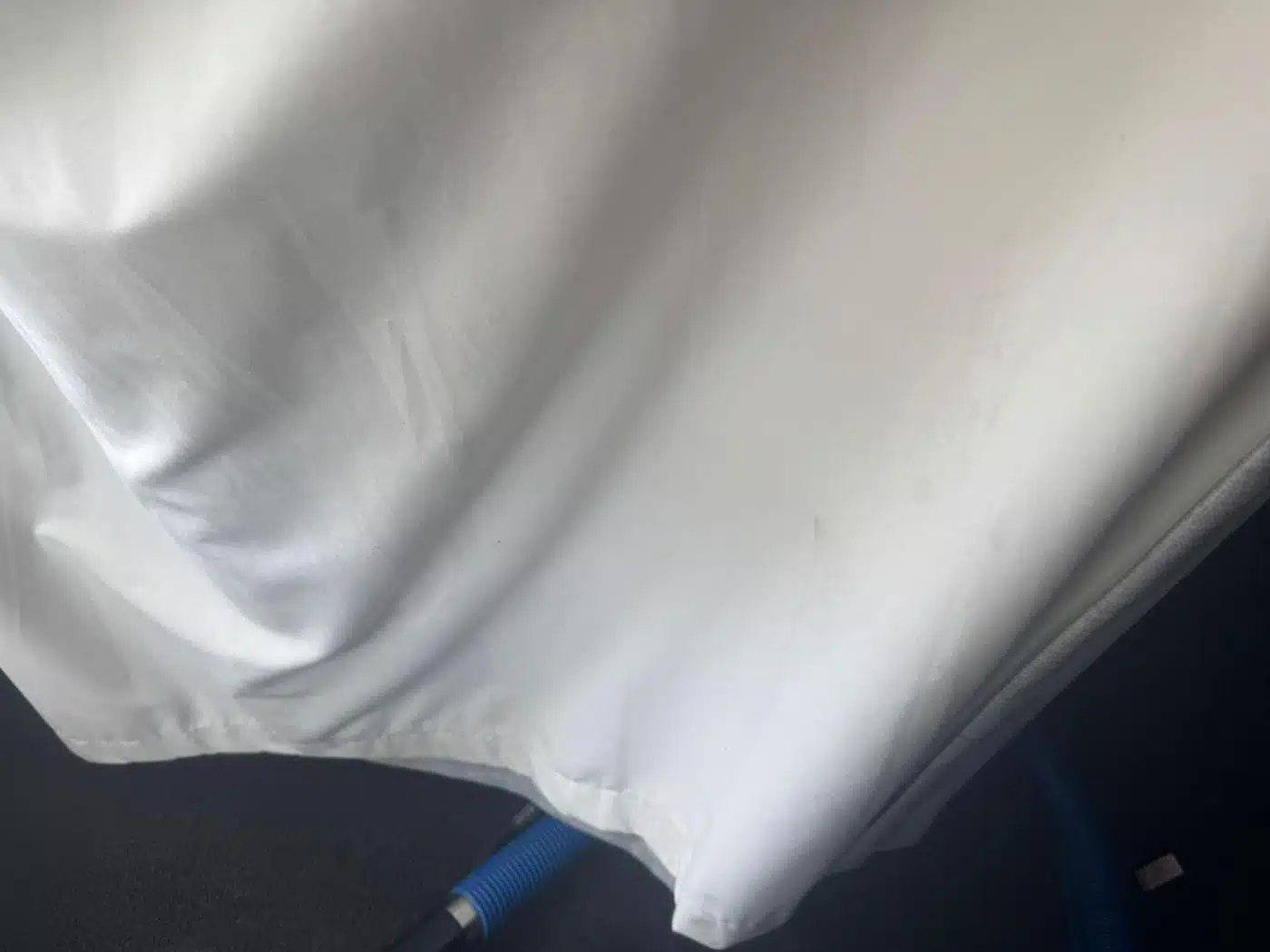 The same white curtain after cleaning, the hem marks removed